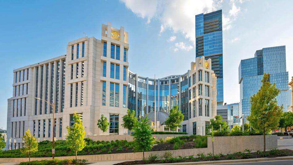 The Fred D. Thompson U.S. Courthouse and Federal Building in downtown Nashville, a stone and glass civic building with a modern glass tower behind it.